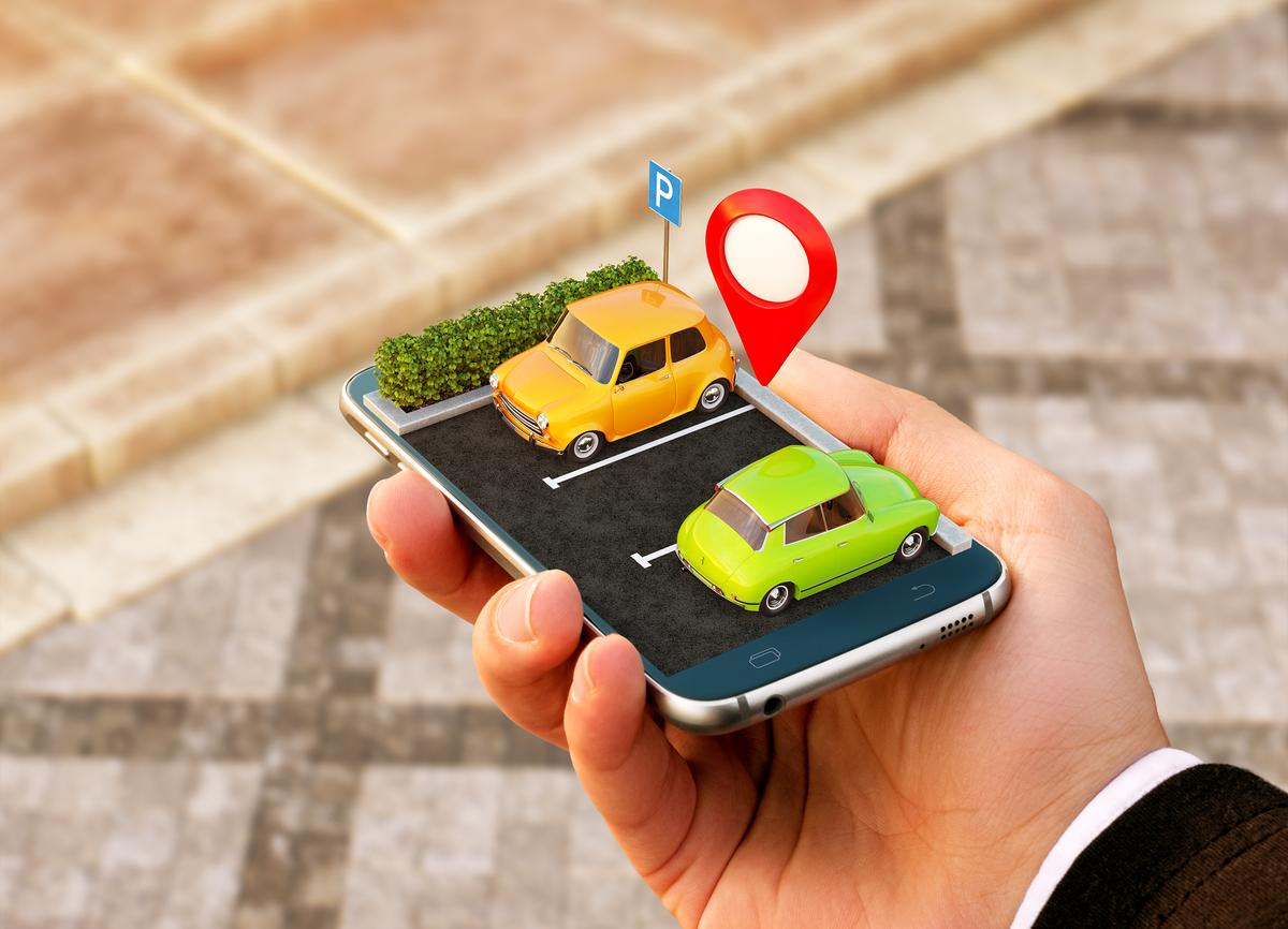 Parking management mobile app showing parked cars and a location pin