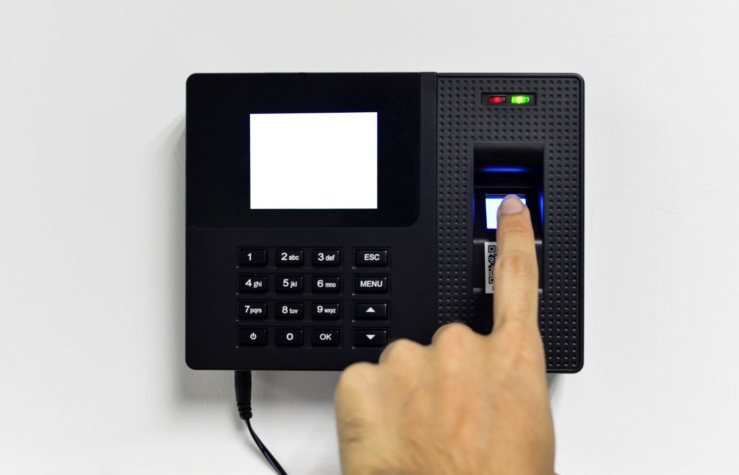 Finger being scanned on a biometric reader at a gate