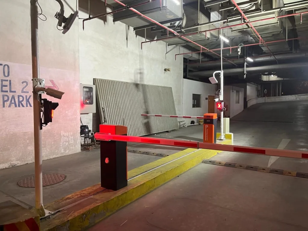 Automatic barrier lane with signal light and camera in a basement car park