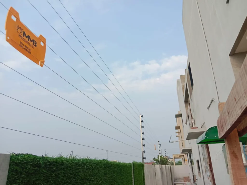 Wall-top electric fence with an MMB Technologies warning sign