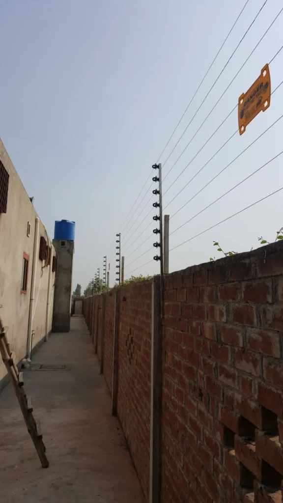 Electric fence running the length of a perimeter wall