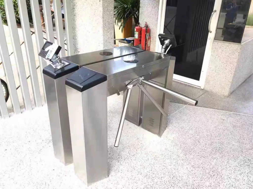 Stainless steel tripod turnstiles with readers at a building entrance