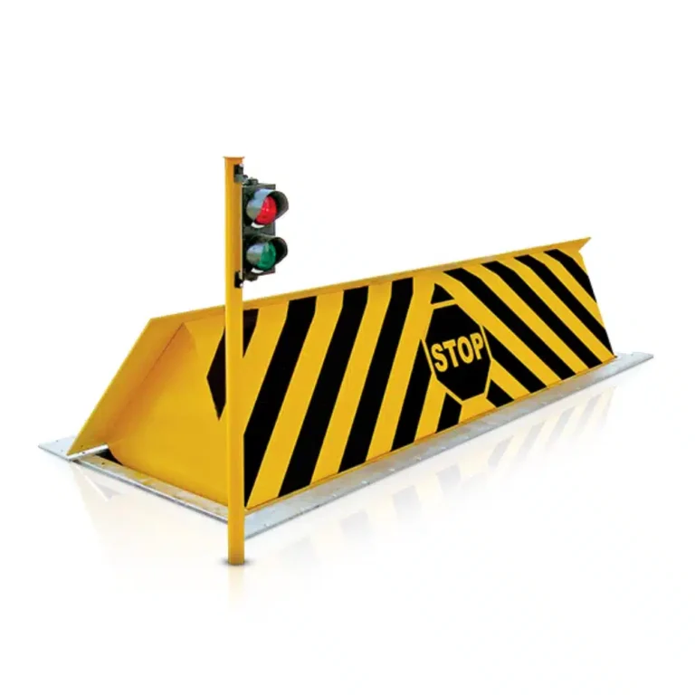 Hydraulic road blocker raised across a lane with a traffic signal